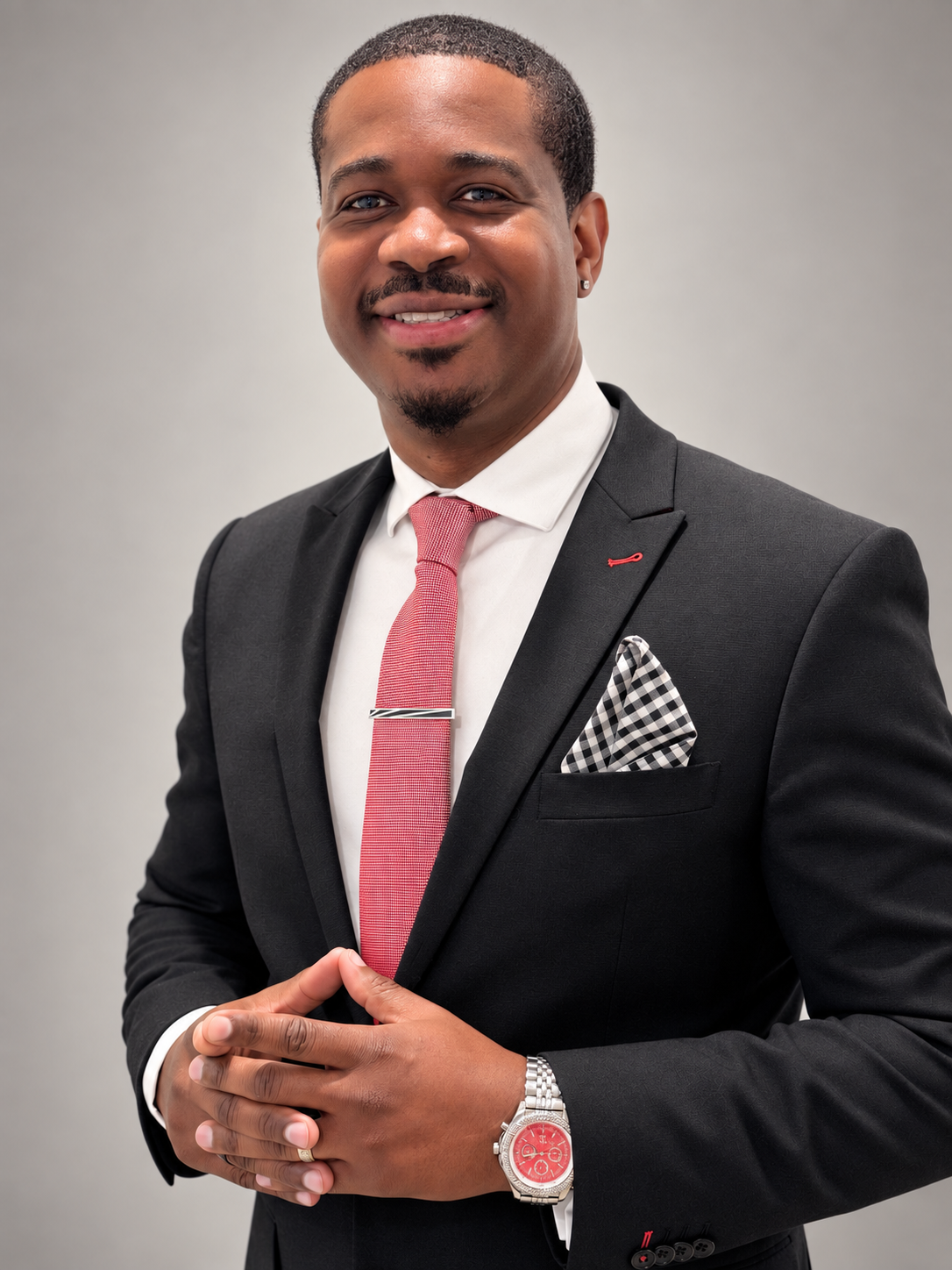 Andre Robinson, CST, wearing a dark suit and red tie